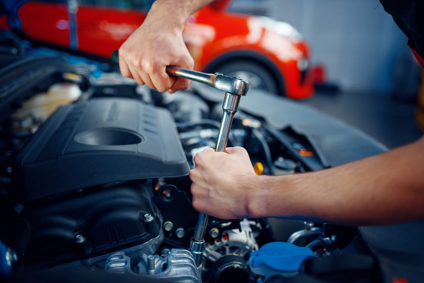 Technician working on a vehicle in the Triplet Auto Repair workshop